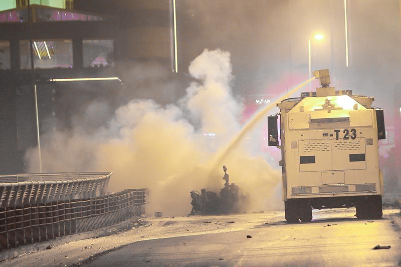 Police extinguish a burning car using a water cannon after a blast in Istanbul, Turkey, December 10, 2016. REUTERS/Murad Sezer - RTX2UGDR